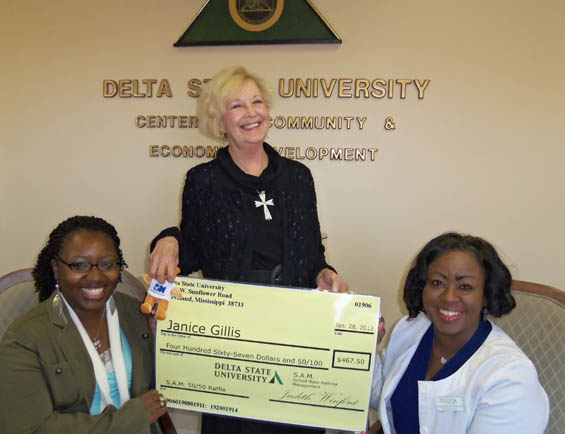 Presenting the check are Marquita Dorsey, AmeriCorps*VISTA  member with SAM (left), and Judith Winford, SAM program director (right).